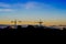 Skyline and silhouette of crane in building construction site on evening background.