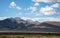 Skyline of snow capped moutains with white clouds