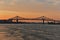 A skyline view a steel bridge across at sunset. Jacques Cartier Bridge across Saint Laurent river, Montreal, Quebec, Canada