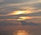 Skyscape with Brilliant Golden Yellow Colors in Cloudy Sky at time of Sunrise over Ocean - Natural Background