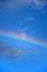 Skyscape with full moon and rainbow