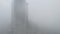 A skyscraper in fog smog smoke clouds in Houston city