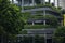 Skyscraper wall with green plants terraces