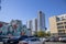 Skyscrapers, apartments and office building in the city skyline with parked cars in a parking lot and a colorful wall mural