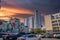 Skyscrapers, apartments and office building in the city skyline with parked cars in a parking lot and a colorful wall mural downto