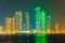 Skyscrapers surrounding the Al Majaz amphitheater situated on an artificial island in Sharjah during night, UAE...IMAGE