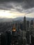 Skyscrapers and towers of Petronas, the capital of Malaysia, Kuala Lumpur, against the backdrop of mountains and sky with clouds a