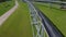 Skyway vehicle drives along overpass railway aerial view