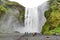 SkÃ³gafoss a waterfall on the SkÃ³gÃ¡ River in the south of Iceland, seen here on a windy day