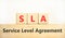 SLA service level agreement symbol. Concept words SLA service level agreement on beautiful wooden blocks. Beautiful white