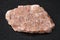 slab from raw pegmatite stone on dark