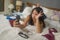 Slackness and chaos at home lockdown - young disorderly and chaotic Asian Korean woman on bed taking selfie with mobile phone on