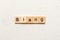 slang word written on wood block. slang text on table, concept