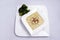 Slant Hero Shot of Broccoli Soup with bread crumbs, oregano on a minimal white background with a 45 degree front facing angle