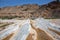 Slanted limestone benches in front of mountain range in Oman`s Wadi al-Arbaeen