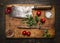 Slasher meat fork meat pepper salt tomatoes, fresh herbs on wooden cutting board top view on rustic wooden background