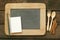 Slate chalkboard and wooden spoon and blank earth tone note book with cinnamon