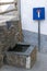 Slate fountain in Alpujarra next to dead end street sign