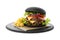 Slate plate with black burger and French fries