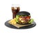 Slate plate with black burger and French fries at glass of cola isolated