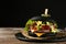 Slate plate with black burger on table