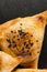 Slate plate with delicious samosas on grey background