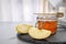 Slate plate with jar of honey, sliced apples and dipper