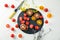 Slate plate with sliced tomatoes on light background