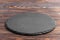 Slate plate on table. black slate stone on wooden background. copy space