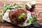 Slate plate with tasty steaks, herbs and spices on wooden background