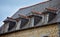 Slate roof and dormer windows in typical houses of French Brittany