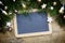 Slate writing board with fir tree branches, christmas balls and