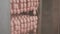 A slaughterhouse worker opens a cabinet in which heat treatment of sausages is made.