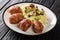 Slavink is ground meat, wrapped in bacon and fried in butter and lard served with mashed potatoes and mushrooms closeup in the