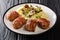 Slavink half-beef, half-pork meatballs are rolled in unsmoked bacon, and cooked in butter served with mashed potatoes and