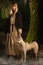 Slavonian girl and siberian husky in the deep forest