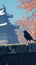 Sleek blackbird rests on a charming low stone barrier