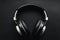 Sleek design, Bluetooth headphones, black leather background, modern audio