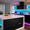 A sleek, futuristic kitchen with holographic countertops, smart appliances, and LED under-cabinet lighting1