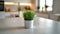 Sleek kitchen with a vibrant green potted grass on the table.