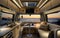 The sleek kitchenette of an RV pairs perfectly with the stunning ocean sunset outside, blending functionality with a