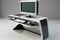 sleek and minimalist computer desk with built-in monitor, keyboard, and mouse