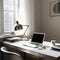 Sleek and Simple Workspace with Silver Laptop and Art in Background