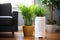 sleek white air purifier near a potted plant