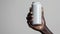 Sleek White Beverage Can Held in African Male Hand for Branding Mockup.