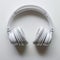 Sleek white headphones arranged neatly on clean white background