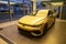 Sleek Yellow VW Golf R sports car parked in showroom, high-performance vehicles, Automotive technology and driver assistance