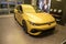 Sleek Yellow VW Golf R sports car parked in showroom, high-performance vehicles, Automotive technology and driver assistance