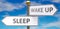 Sleep and wake up as different choices in life - pictured as words Sleep, wake up on road signs pointing at opposite ways to show