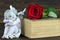 Sleeping angel, red rose and old book